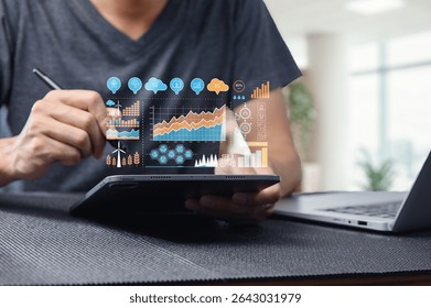 A professional workspace featuring a person using a tablet to display an innovative digital dashboard. Visualize sustainability and technology trends through data analytics and exciting graphics.
