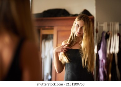 Professional Yet Alluring. Shot Of A Beautiful Young Woman Getting Dressed In Her Bedroom At Home.