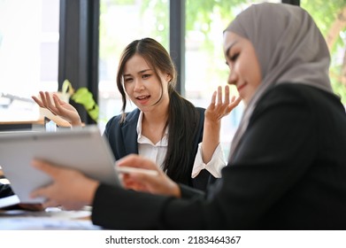 Professional Young Asian Female Boss Or Manager In The Meeting Listening Her Female Employee Presenting The Project.