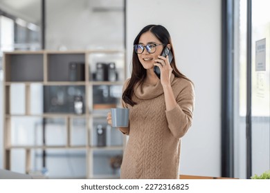 Professional young business asian woman at workplace and talking 0n Phone working on laptop computer - Powered by Shutterstock