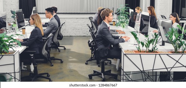 professional young business people working with desktop computers in open space office  - Shutterstock ID 1284867667