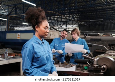 A Professional Young Female Industry Engineer Worker Works In A Safety Uniform With Metalwork Precision Tools, Mechanical Lathe Machines, And Spare Parts Workshop In The Steel Manufacturing Factory.