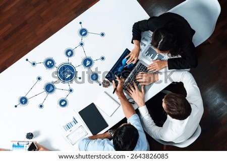 Professionals collaborate on data analysis at a modern office table, illustrating digital connectivity through technology icons and emphasizing teamwork for business insights. Amity