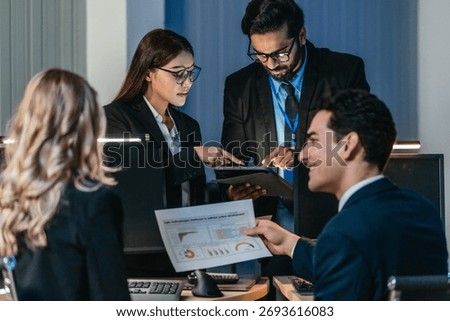 Professionals collaborate in  tech environment. Senior members coaching, mentoring, guiding colleagues through data analytics and software development. Knowledge sharing, leadership, technical growth