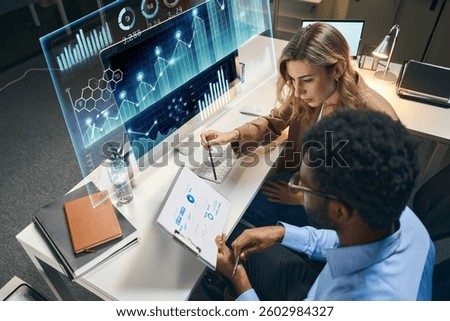 Professionals Collaborating Using Advanced Data Analytics and Graphic Tools at a Modern Workspace
