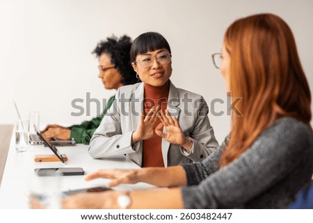 Professionals engaged in a collaborative discussion at a workplace, emphasizing organizational teamwork and communication in a professional environment.