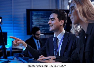 Professionals in a future workshop learn to collaborate with an AI, taking notes as the AI explains its complex code, a process known as augmented cognition for rapid upskilling.