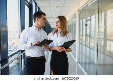 Professionals Having A Discussion In A Office Setting.