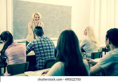 Professionals And Smiling Adult Female Coach At Training Session For Employees