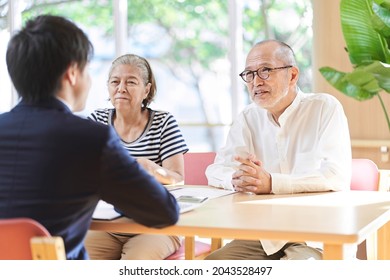 Professionals who give advice on inheritance to elderly couples - Shutterstock ID 2043528497