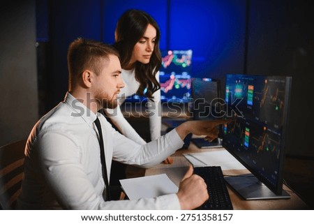 Professionals working on financial analytics, discussing investment strategies and monitoring cryptocurrency trends in a tech driven office