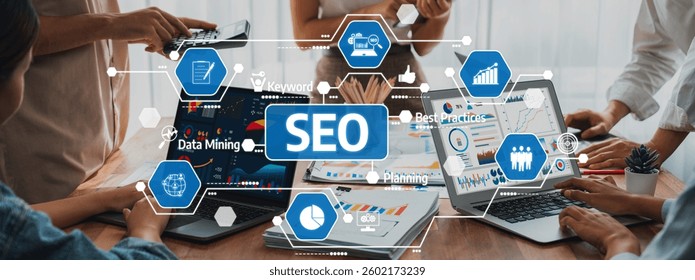 Professionals working together in an office setting, utilizing laptops and data mining techniques to develop effective SEO strategies and best practices. Amity