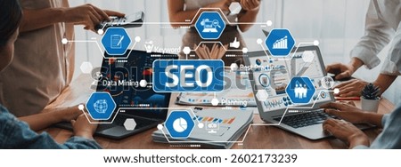 Professionals working together in an office setting, utilizing laptops and data mining techniques to develop effective SEO strategies and best practices. Amity