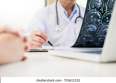 Professor Doctor Discussion A Method With Patient Treatment, With Mammogram Film X-ray Of Patient 's Head For Brain, Skull Or Eye Injury And Laptop Computer On Table.