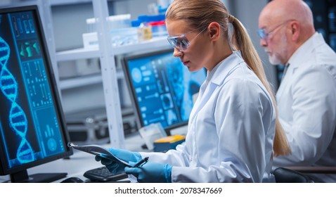 Professor And Doctor Work In A Modern Scientific Laboratory Using Equipment And Computertechnologies. Group Of Scientists Make Research And Develop New Vaccines. Science And Healthcare Concept.