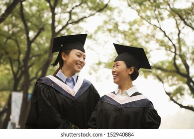 Professor And Graduate Walking On Campus