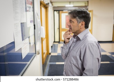 Professor Reading Notice Board In College