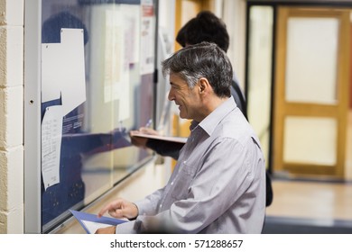 Professor Reading Notice Board In College