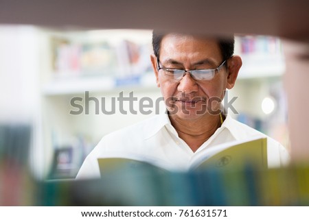 The professor is searching for knowledge in the library.