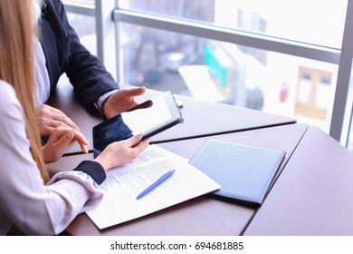 Professor and student settle question by using tablet and studying outside classes atuniversity, experienced man try to use gadget for school project with young smartstudent. Beautiful stately grey