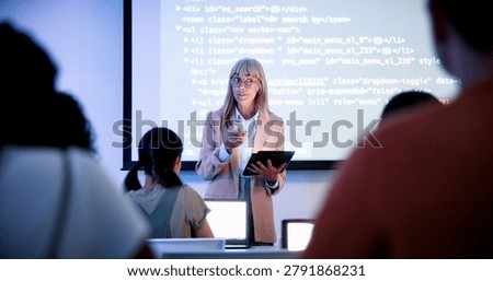 Professor, students and presentation with tablet in classroom, programming course and IT curriculum. University, people or mature lecturer with software algorithm for coding lesson, education or tech