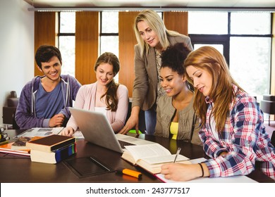 Professor Teaching Group Of Students In Library At The University