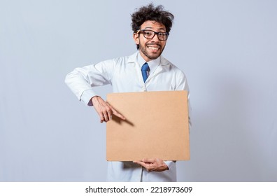 Professor In White Coat Holding A Blank Clipboard Isolated. A Scientist In A White Coat Is Holding A Blank Clipboard. Scientist Showing And Pointing At A Blank Clipboard