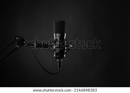 Proffesional studio microphone, isolated on the black background ready for podcasts recording.