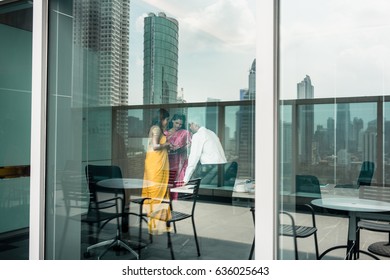 Proficient Indian Business People At Work In A Modern Office Building With Panoramic City View