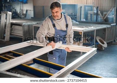 Proficient worker engaged in construction of PVC doors and windows