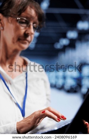 Proficient worker using laptop, ensuring data remains shielded from potential security jeopardy, safeguarding server room infrastructure against unauthorized access and vulnerabilities, close up
