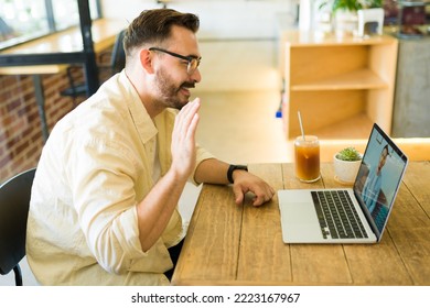 Profile Of An Attractive Man In His 30s Iced Coffee While Making A Work Video Call At The Coffee Shop