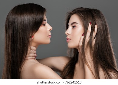 profile of beautiful twins women with perfect skin and natural make-up and long hair. fashion