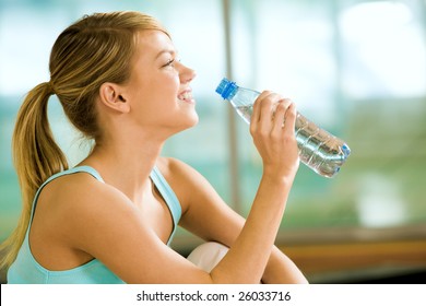 Profile Of Beautiful Woman Going To Drink Some Water Fron Plastic Bottle After Workout