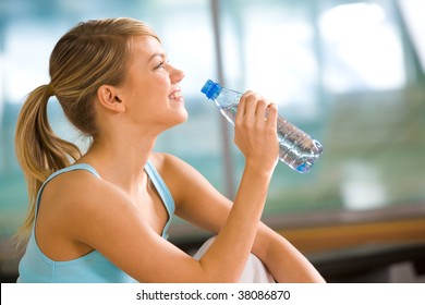 Profile Of Beautiful Woman Going To Drink Some Water From Plastic Bottle After Workout