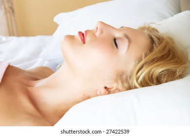 Profile Of A Beautiful Young Blond Woman Sleeping Peacefully In Her Bed At Home