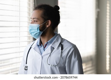 Profile Close Up Pensive African American Man Doctor In Medical Mask Thinking, Looking At Window In Hospital, Confident Thoughtful Physician Practitioner In White Uniform Planning, Visualizing