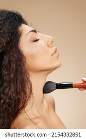 Profile Close Up Portrait Of Enjoyed Adorable Tanned Awesome Curly Latin Lady Hold Makeup Brush On Shoulder Apply Highlighter Satisfied Posing Isolated On Pastel Beige Background Close Eyes. Banner