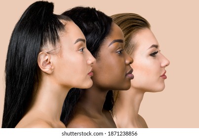 Profile close up portrait of three beautiful multiracial women, Asian, African and Caucasian, with different types of skin and hair, posing over beige background. Natural beauty of women. Copy Space - Shutterstock ID 1871238856