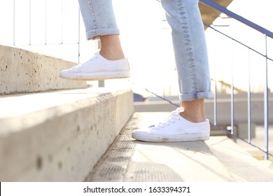 Profile Close Up Of Woman Legs Wearing Sneakers Walking Up Stairs