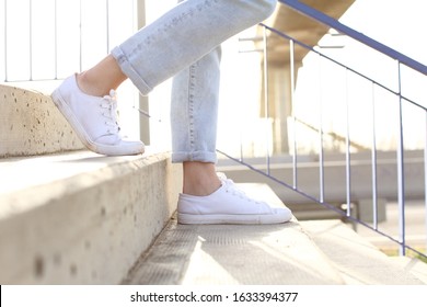 Profile Close Up Of Woman Legs Wearing Sneakers Walking Down Stairs