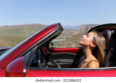 Profile of a convertible car driver breaths fresh air - Powered by Shutterstock