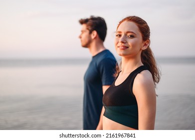 Profile couple young two friend strong sporty sportswoman sportsman woman man in sport clothes warm up training look camera do exercise on sand sea ocean beach outdoor on seaside in summer day morning - Shutterstock ID 2161967841
