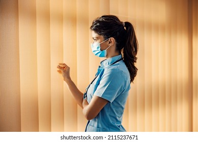 Profile Of A Female Doctor Looking Trough Window. Medical Staff And Medical Support.