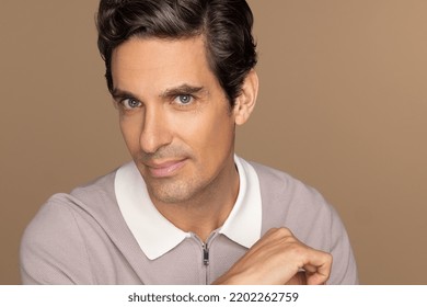 Profile Of A Gorgeous Latino Man In His 40's Smiling On A Neutral Background.