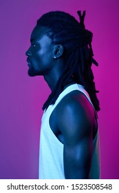 Profile Of Handsome Afro Guy With Stylish Dreads, Close Up Side View Portrait, Stylish And Fashion Concept. Isolated Pink And Violet Background