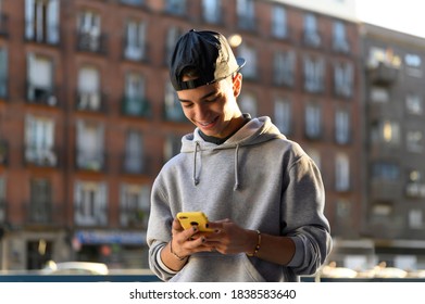 Profile of a happy guy using a smart phone
