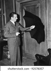 Profile Of A Man Opening An Umbrella