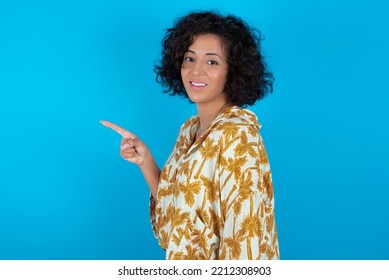 Profile Photo Of Brunette Arab Woman Wearing Hawaiian Shirt Over Blue Background Indicate Finger Empty Space Offer