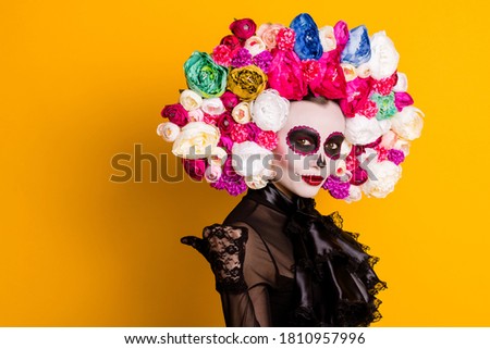 Profile photo of calavera katrina directing thumb empty space traditional folklore character wear black dress death carnival costume roses headband isolated yellow color background